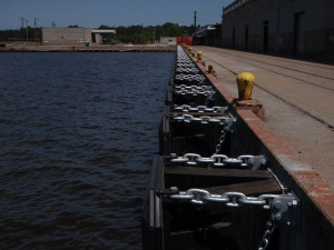 Removal and replacement of 1100 lf of timber pile and timber chock fender system. Resurfacing concrete facia and installation of new Ultra High Molecular Weight Polyethylene ship fender panels.