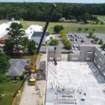 Crofton Crane Rental & Rigging's 300-ton Grove places tilt up panels in Chesapeake, VA.