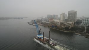 Crofton Crane Rental & Rigging's 85-ton floating crane derrick, the Scott's Creek, transports big top fabric shell.