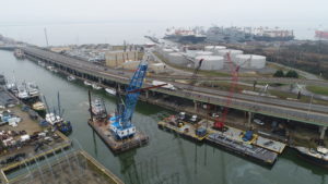 Crofton Crane Rental & Rigging's 85-ton floating crane derrick, the Scott's Creek, transports big top fabric shell.