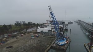 Crofton Crane Rental & Rigging's 85-ton floating crane derrick, the Scott's Creek, transports big top fabric shell.