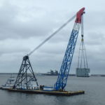 Crofton Crane Rental & Rigging's 350-ton floating derrick, The Samson, lifts 110-ton generator on to the Theodore Roosevelt.