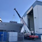 Crofton Crane Rental & Rigging's 90-ton Link-Belt placing a crane boom back on the ship