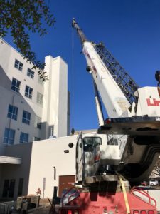 Crofton Crane Rental & Rigging's 90-ton Link-Belt setting roof top equipment in Norfolk, VA